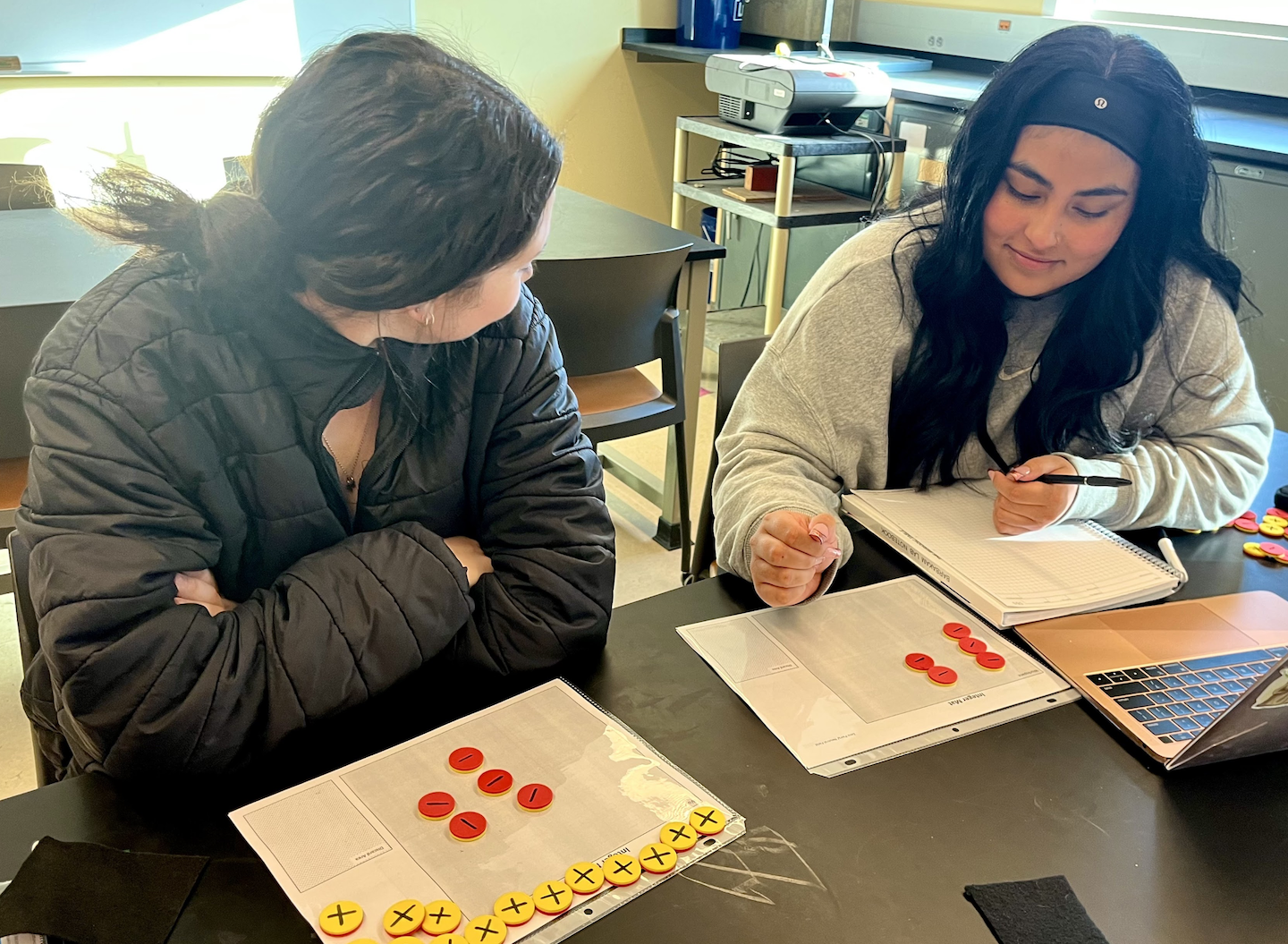 Two students working together in a classroom