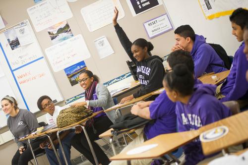 Student raising hand to ask a question.