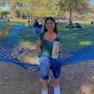 Ana Hernandez sitting on a hammock in the quad, holding a waterbottle